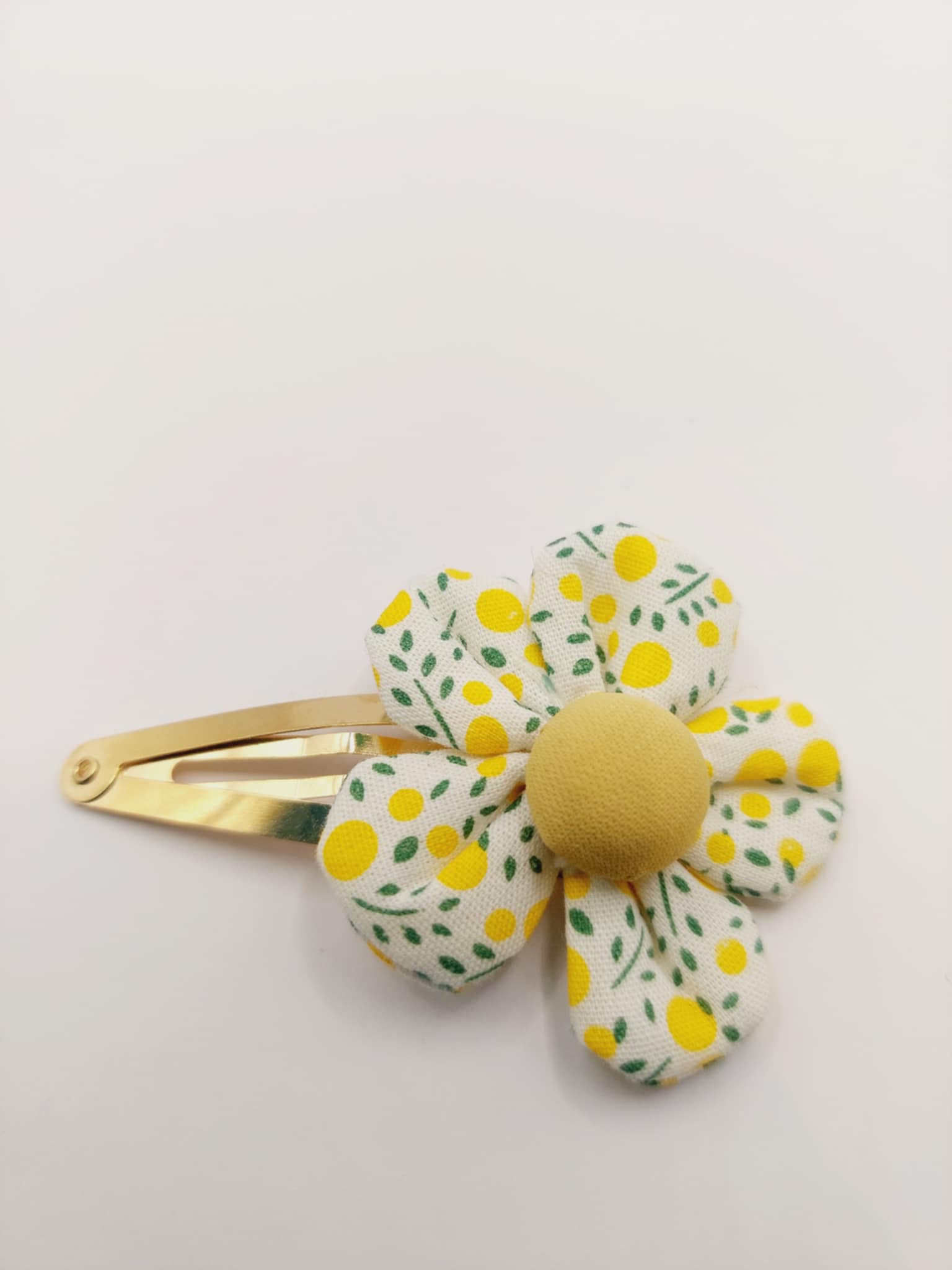Haarclip met een rubber coating met een geel bloem